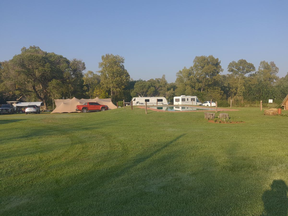 Caravans and tents on a wide lawn