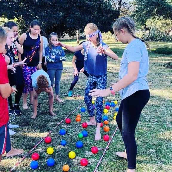 Learners playing a team game on the lawn